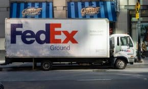FedEx delivery truck parked on an urban street, highlighting city logistics.