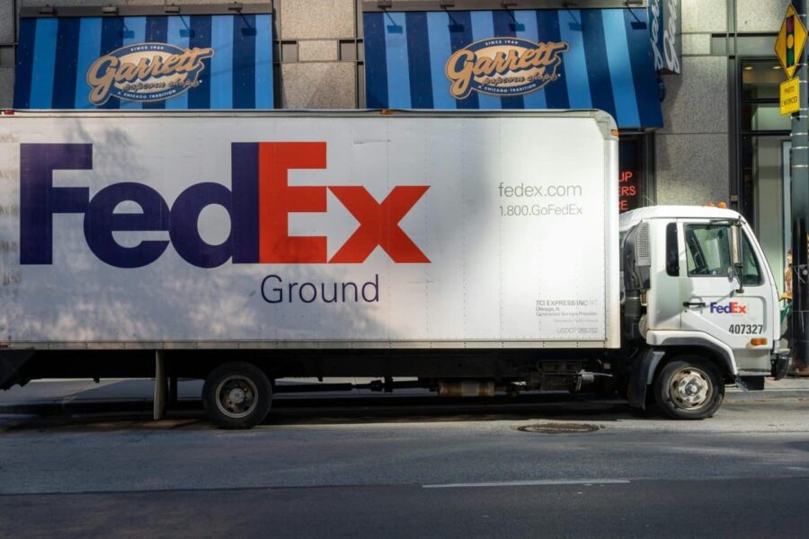 FedEx delivery truck parked on an urban street, highlighting city logistics.
