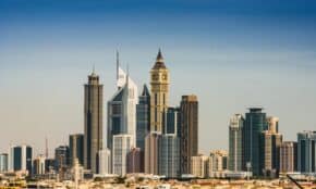 Panoramic view of Dubai's modern skyline featuring iconic skyscrapers in the financial district under a clear sky.