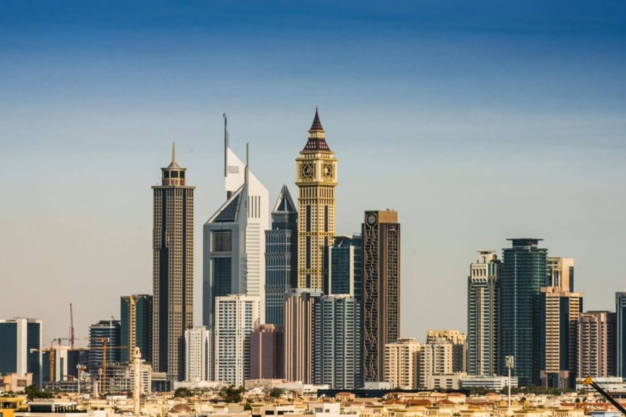Panoramic view of Dubai's modern skyline featuring iconic skyscrapers in the financial district under a clear sky.