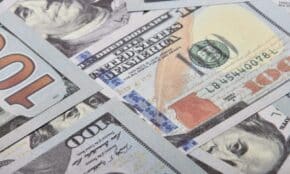 Detailed close-up of multiple US dollar banknotes showing currency details and design.