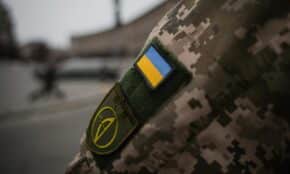 Detailed shot of Ukrainian military uniform with flag patch, symbolizing national pride.
