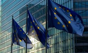 EU flags waving in front of the European Commission building in Brussels, Belgium.