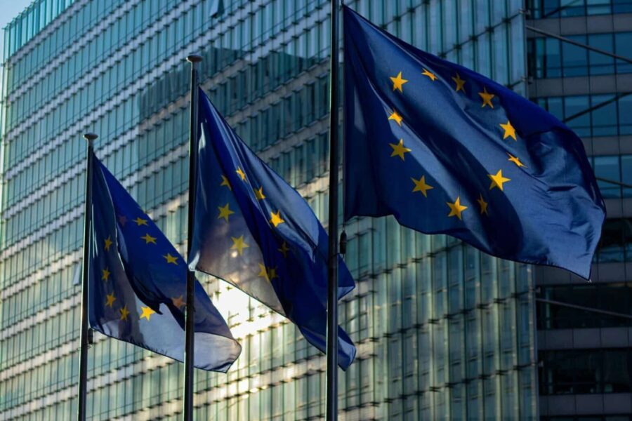 EU flags waving in front of the European Commission building in Brussels, Belgium.