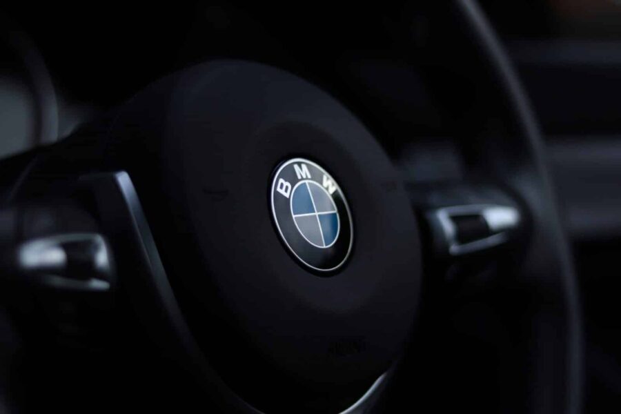 Detailed view of a BMW steering wheel emblem with a stylish depth of field effect.