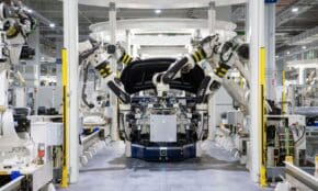 High-tech robots assembling a car in a modern factory setting, showcasing automation.