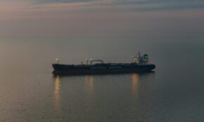 Oil tanker 'Northsea Shipping' sailing on calm waters during twilight, reflecting a serene scene.