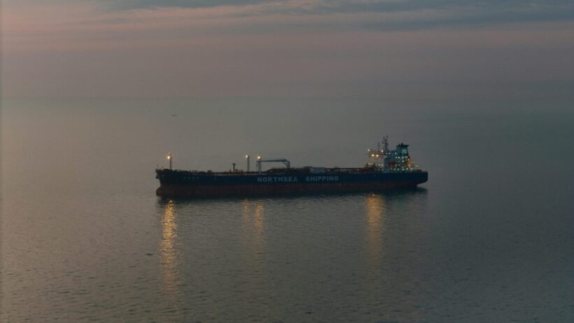 Oil tanker 'Northsea Shipping' sailing on calm waters during twilight, reflecting a serene scene.
