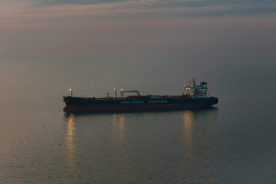 Oil tanker 'Northsea Shipping' sailing on calm waters during twilight, reflecting a serene scene.