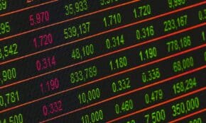 Close-up of a digital stock market data display showing colorful financial numbers and trends.