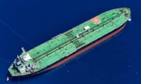 Aerial shot of an oil tanker sailing in the ocean near Vado Ligure, Italy.