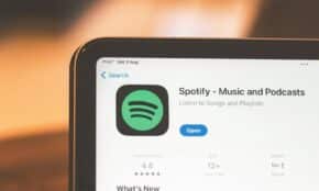 Close-up of Spotify app page displayed on a tablet screen, highlighting its features.