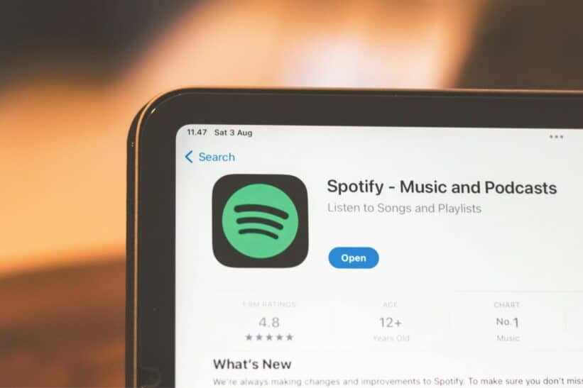 Close-up of Spotify app page displayed on a tablet screen, highlighting its features.