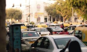 Busy street scene with congested traffic in New Delhi, India. Captured in vibrant daylight showcasing city hustle.