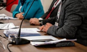Close-up of professionals discussing documents at a business meeting in Ankara, Turkey.