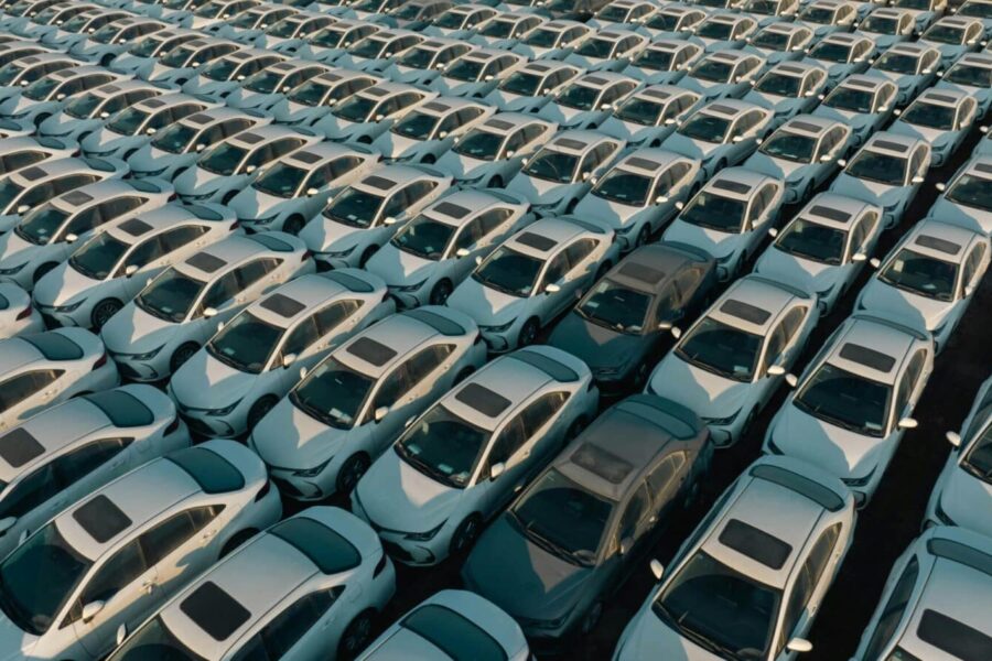 Overhead view of neatly arranged cars in a Libyan parking lot, captured at day.