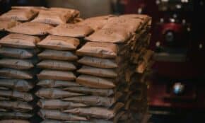 Stacked brown paper packages in an industrial warehouse setting. Perfect for logistics visuals.