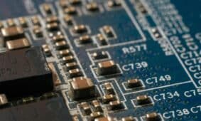 Detailed macro shot of a circuit board highlighting electronic components and traces.