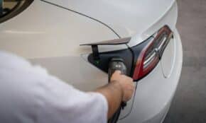 Close-up of an electric car being charged, emphasizing modern sustainable technology.