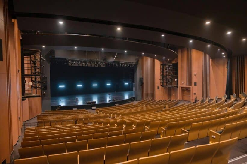 Spacious empty theatre auditorium with wooden seating in Varanasi, India.