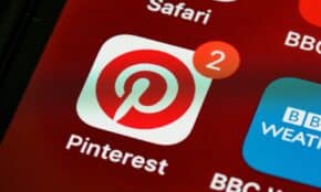 Close-up of Pinterest app icon and notifications on a smartphone screen, detailed and vibrant technologically themed image.