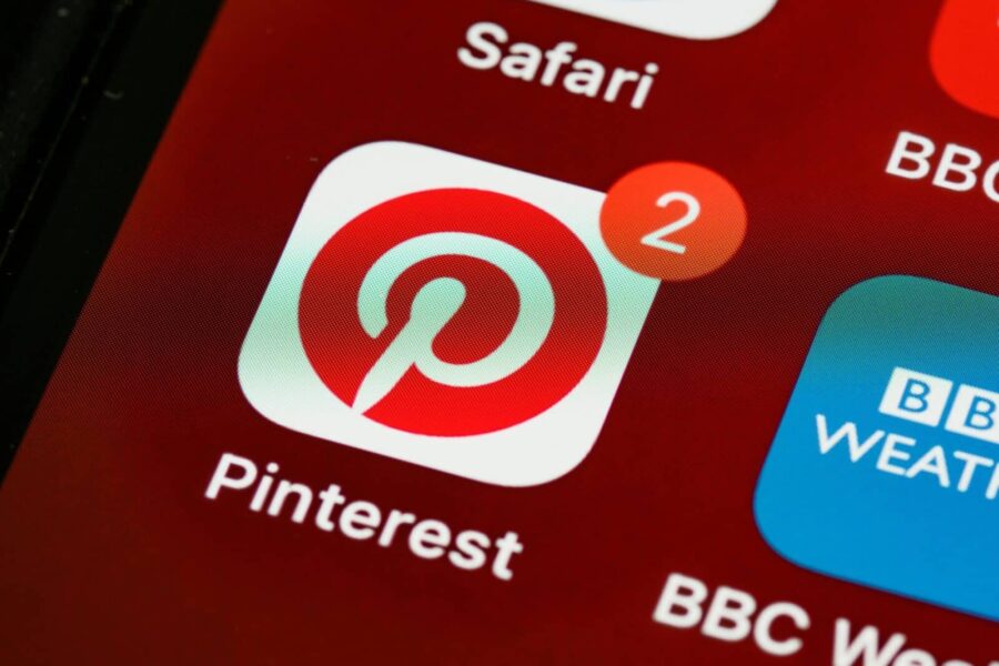 Close-up of Pinterest app icon and notifications on a smartphone screen, detailed and vibrant technologically themed image.