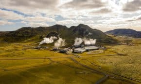 Aerial view of Hellisheidi geothermal power plant with mountains and steam in Iceland
