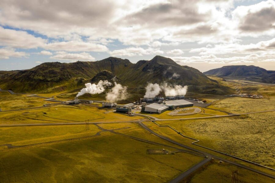 Aerial view of Hellisheidi geothermal power plant with mountains and steam in Iceland