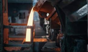 Molten metal pouring in a foundry, showcasing intense industrial processes.