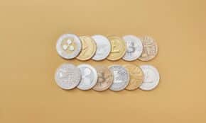 A collection of digital cryptocurrency coins, including Bitcoin and Ethereum, arranged on a stylish gold backdrop.