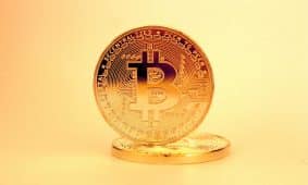 A close-up of a golden Bitcoin highlighting its digital currency design.