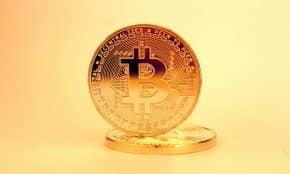 A close-up of a golden Bitcoin highlighting its digital currency design.