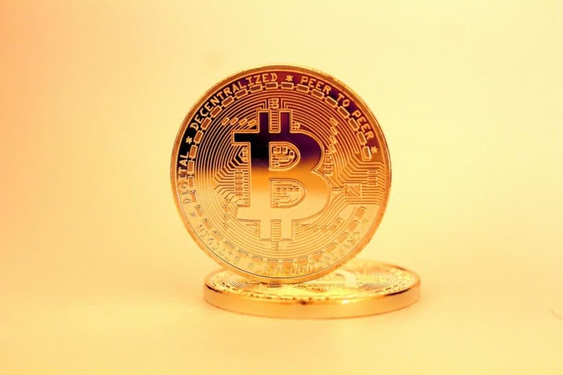A close-up of a golden Bitcoin highlighting its digital currency design.