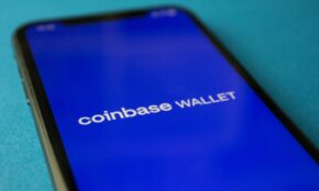 Close-up of a smartphone showing the Coinbase Wallet app interface for cryptocurrency transactions.