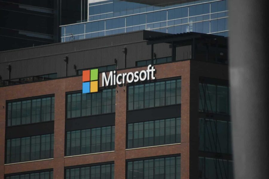 A tall building with a microsoft logo on top of it