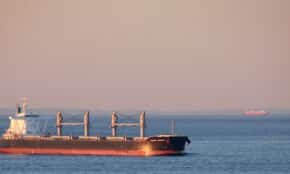 red ship on sea under gray sky during daytime