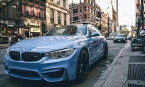 blue BMW coupe parked on the road during daytime