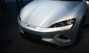 a white sports car is on display at a car show