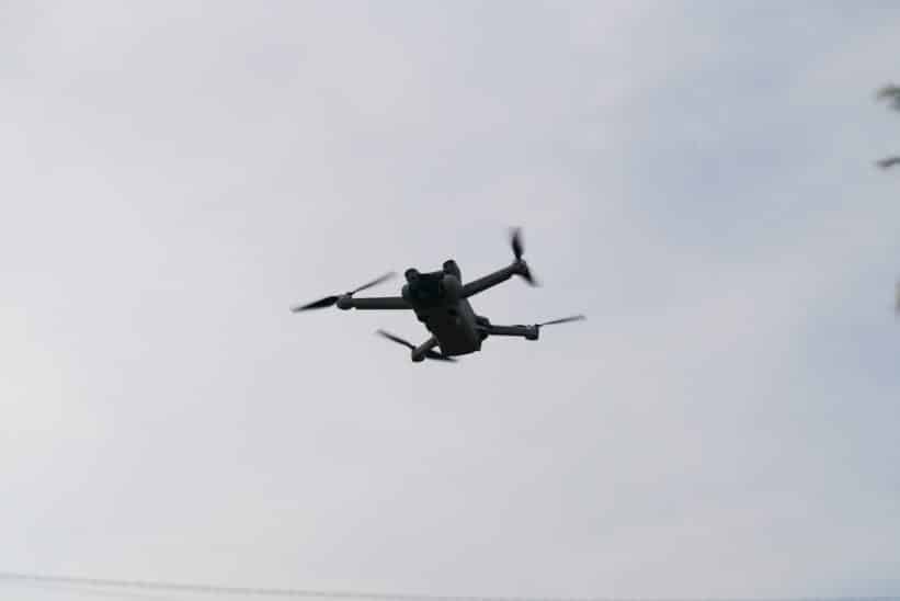 A drone flies in the cloudy sky