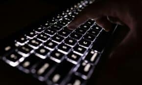person holding black computer keyboard