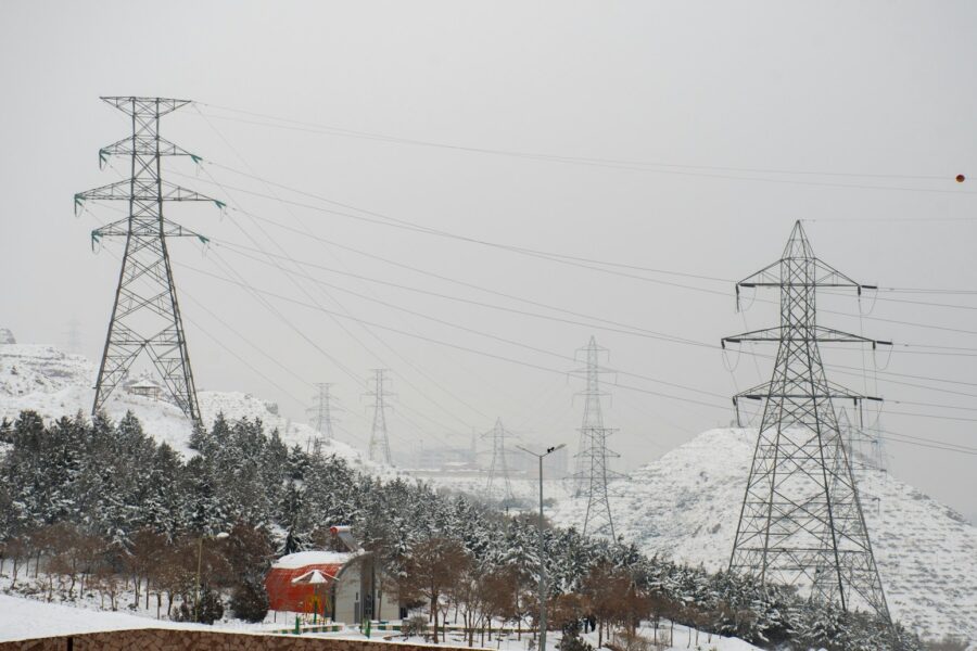 a snow covered mountain with power lines in the background