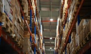 Rows of shelves stacked with boxes in a warehouse.