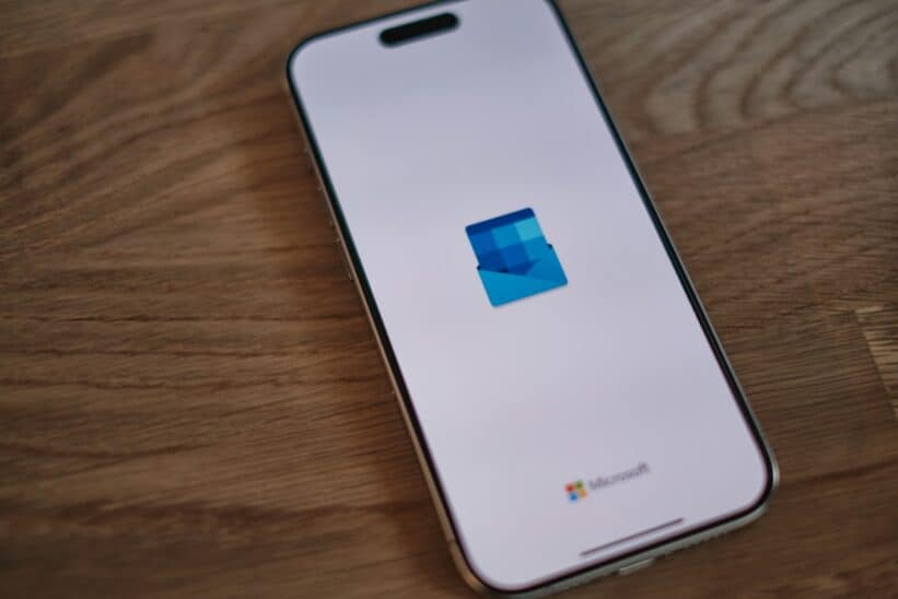 A white cell phone sitting on top of a wooden table