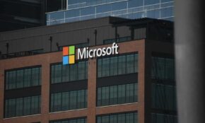 A tall building with a microsoft logo on top of it