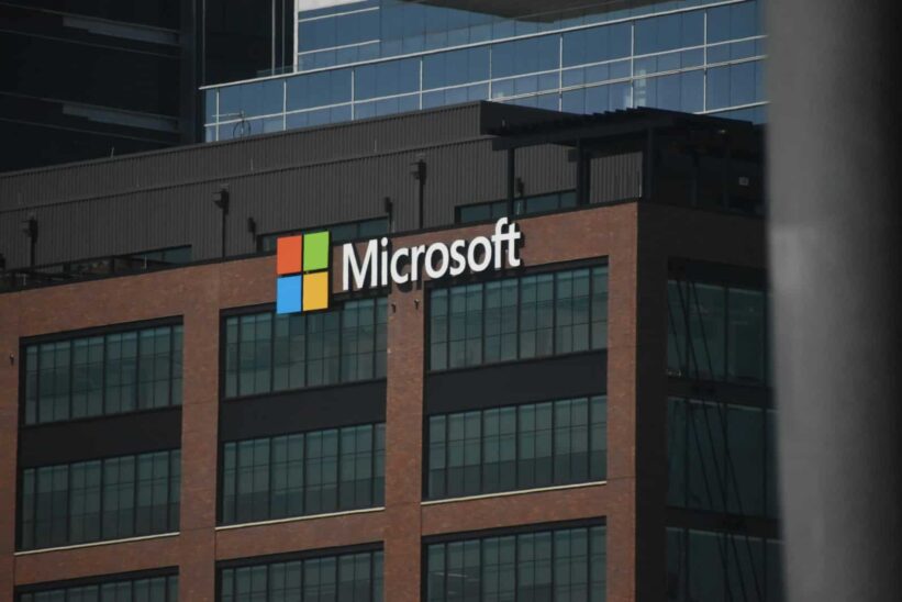 A tall building with a microsoft logo on top of it