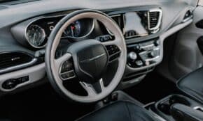 the interior of a car with a steering wheel and dashboard