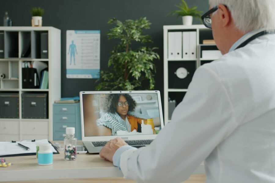 Doctor consults with patient via video call.