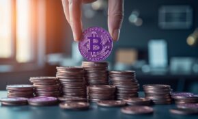 Hand placing purple 'S' cryptocurrency coin on staking platform with growing coin stacks in office environment