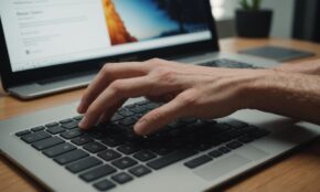 Hand hovering over laptop keyboard with glowing privacy settings buttons on screen in natural home office lighting