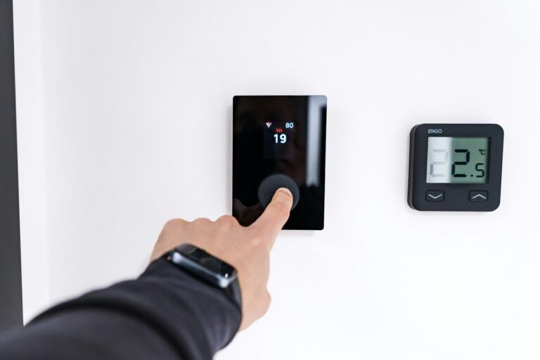 Person adjusting thermostat